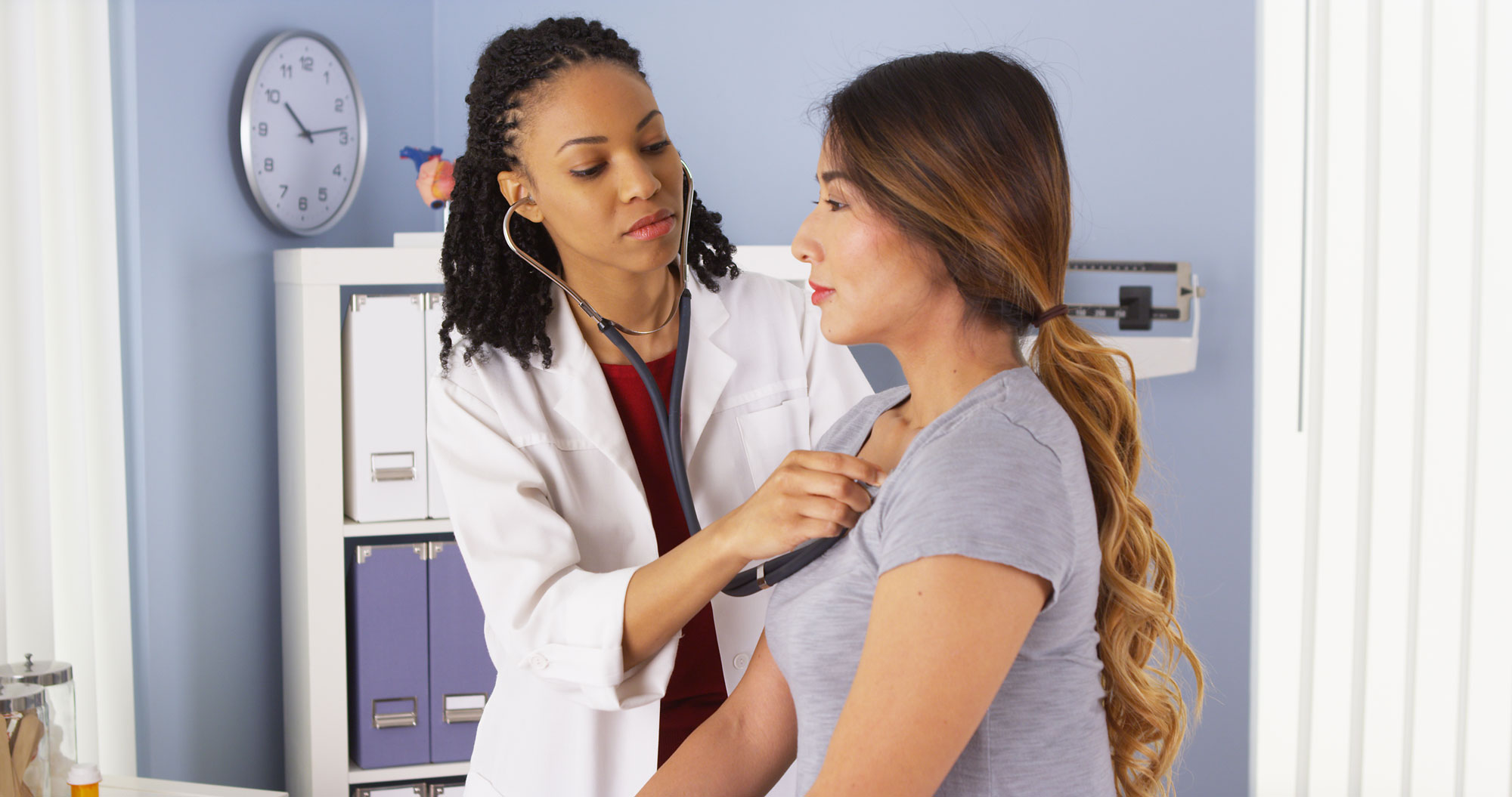 nurse checking woman’s heartbeat